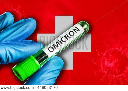 Switzerland Outbreak Of Omicron Variant. A Hand In A Blue Rubber Glove Holds A Test Tube With Covid-