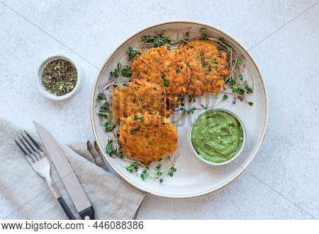 Sweet Potato Fritters With Creamy Avocado Dip On Ceramic Plate. Healthy Vegan Food Concept. Top View
