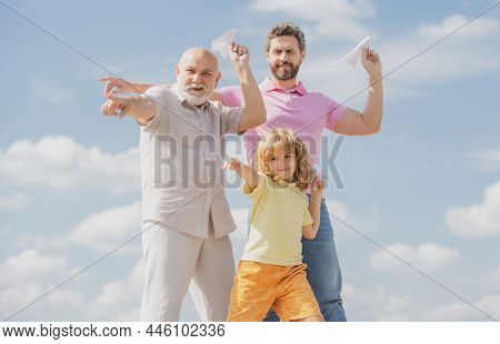 Active Family Leisure With Kids. Boy Son With Father And Grandfather With A Toy Airplane Plays On Su
