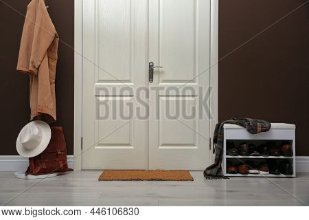 Shelving Unit With Shoes, Coat Rack And Door Mat In Hall