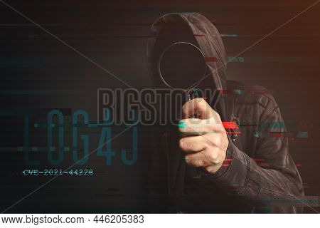 Hooded Computer Hacker In Cybersecurity Vulnerability Log4j Concept With Digital Glitch Effect
