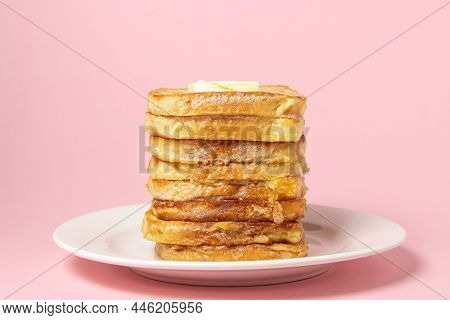 Eggy Bread On A Pink Background. Butter Melts On A Stack Of Eggy Breads. Tasty Breakfast.