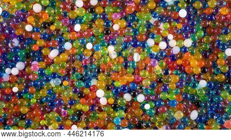 Water beads close-up, abstract background. Texture of Hydrogel balls or many colorful orbeez for wallpaper.