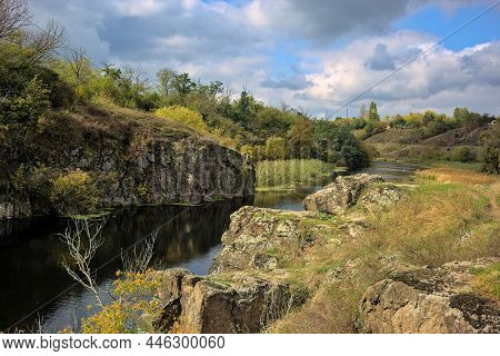 Vertical Stone Rocks On The Bank Of The River. A Picturesque View Of The Tyasminsky Canyon With Rive