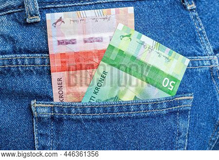Banknotes Of Norwegian Krone Sticking Out Of The Blue Jeans Pocket Close Up