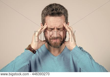 Mature Man With Beard Suffer From Headahce On Grey Background, Health
