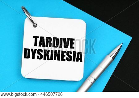 On The Black Surface Lies Blue Paper, A Pen And A Notebook With The Inscription - Tardive Dyskinesia