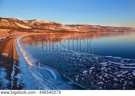 Frozen Lake Baikal In The Morning. View Of The Transparent Ice From Cape Uyuga, Kurma.