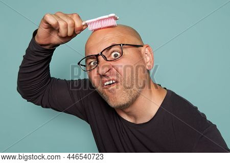 Inadequate Man With Glasses And A Beard, After Becoming Bald, Combs His Head With A Childs Comb And 