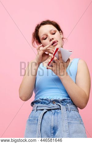 Portrait Of A Woman In A Blue T-shirt With A Red Notepad And A Pen Of Emotions Close-up Unaltered