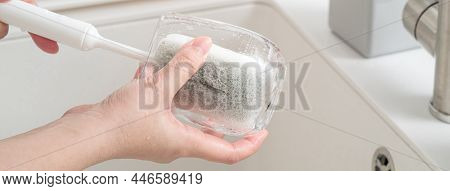 Woman Housewife Is Doing The Dishes At Home Kitchen.
