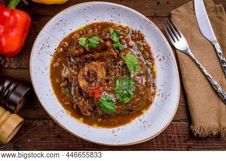 Osso Buko On Plate Top View On Wooden Table