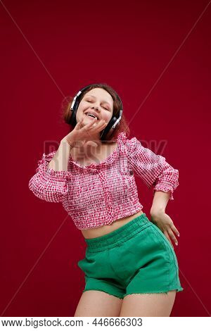 Cheerful Woman Listening To Music With Headphones Dance Unaltered