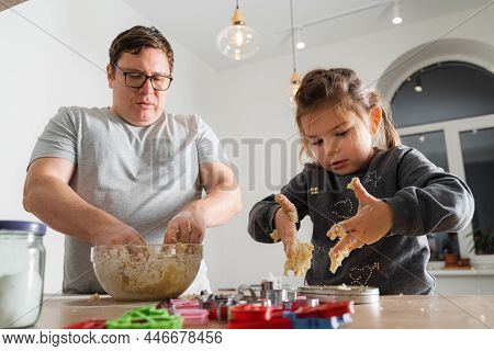Father Feeling Playful With His Caucasian Little Daughter, While Preparing Homemade Dough For Tasty 