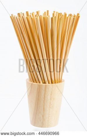 Wheat Straw For Drinking Water In Wooden Glass On White Background. Zero Waste Concept.