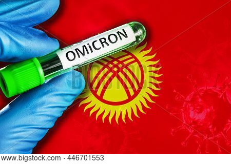 Kyrgyzstan Outbreak Of Omicron Variant. Hand Holds A Test Tube With Covid-19 Virus Omicron In Front