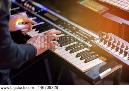 Close Shooting Of A Keyboardist Musician At Work At A Concert. Keyboardist Play Keyboard On Stage