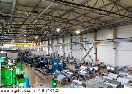 Photo Shot Of Roll Of Painted Galvanized Steel Sheet At Cutting Machine, Ironworks And Metalwork In 