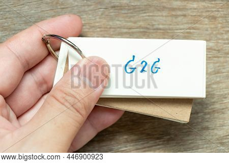 Man Hold The Flash Card With Handwriting Word G2g (abbreviation Of Government To Government) On Wood