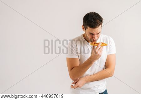 Portrait Of Sick Upset Young Man Feeling Pain In Stomach After Eating Pizza, Suffering Abdomen Ache,