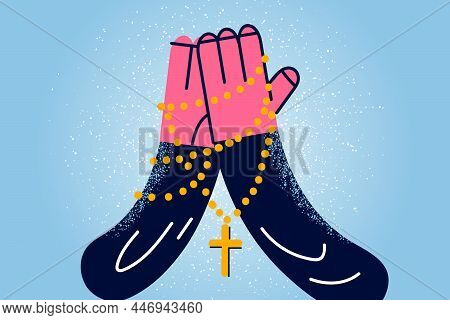 Close Up Of Person Hands With Cross On Chain In Hands Pray To God. Religious Man Believer Feel Thank