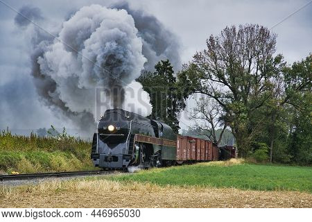 Ronks, Pennsylvania, October 2019 - An Antique Restored Steam Freight Train Approaching Blowing Smok
