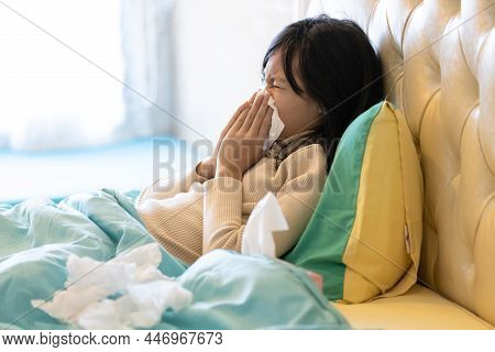 Sick Child Girl Have A Cold,blowing Nose In Paper Handkerchief In Bedroom,flu Or The Weather Is Chan