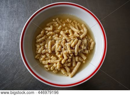 Homemade Italian Passatelli. Traditional Italian Pasta Cooked In Broth. View From Above. Bologna, It