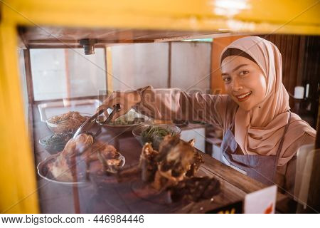 Woman With Hijab Working In Her Tradtional Food Shop