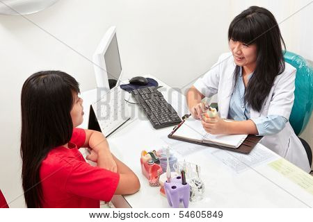 Patient consulting her teet problem with the dentist in dental clinic