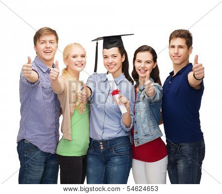 education and people concept - group of standing smiling students with diploma and corner-cap showing thumbs up