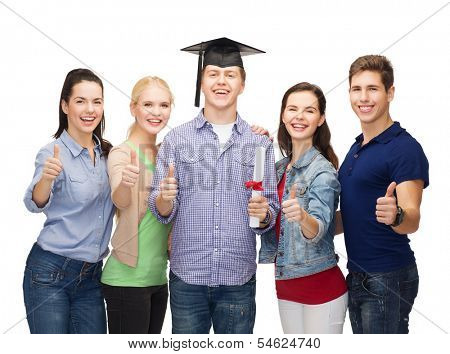 education and people concept - group of standing smiling students with diploma and corner-cap showing thumbs up