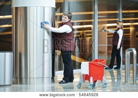 two woman cleaner worker in uniform cleaning indoor interior of business building