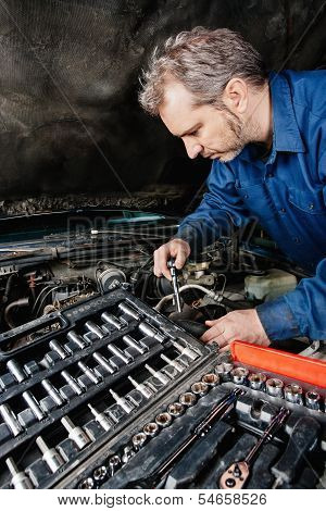 Mechanic Fixing An Engine