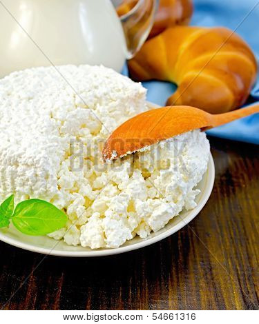 Curd On A Saucer With A Spoon On A Board