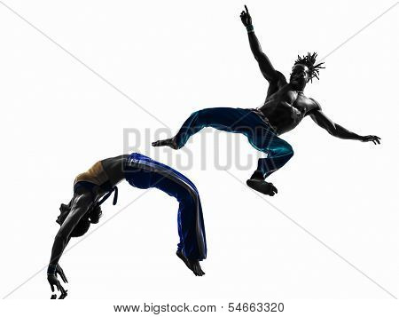 two people couple capoiera dancers dancing in silhouette studio isolated on white background