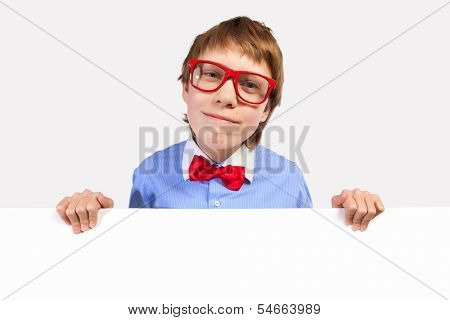 Image of confused boy holding white square. Place for advertisement