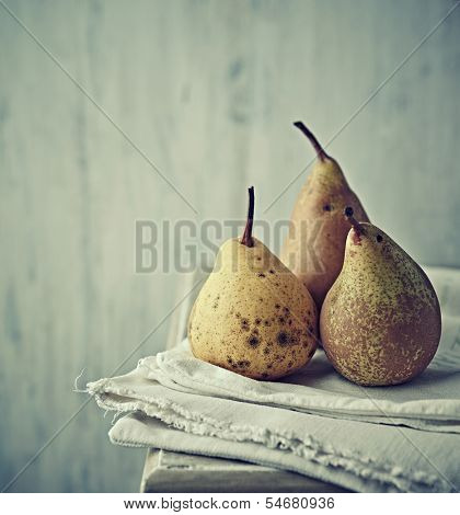 Still life with autumn pears on linen
