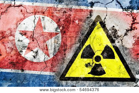 Old Cracked Wall With Radiation Warning Sign And Painted Flag