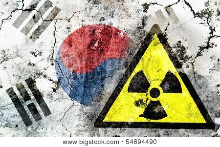 Old Cracked Wall With Radiation Warning Sign And Painted Flag