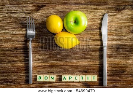Lemons And Apple On Wooden Vintage Table With Silverware