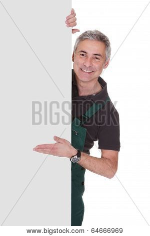 Mature Male Gardner Holding Placard