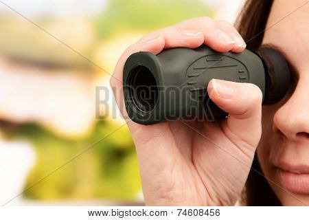 Modern monocular in hands on bright background