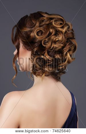 Rear View Of Woman's Festive Hairstyle. Waved Hairs