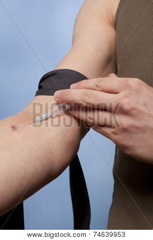 Drug addict man with syringe in action