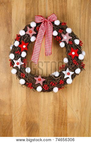 Decorated Christmas Door Wreath Red White Cloth Stars And Gingham Bow On Sapele Wood Background