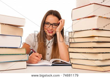 Happy Asian Caucasian Girl Lerning In Study Woth Lots Of Books On The Table