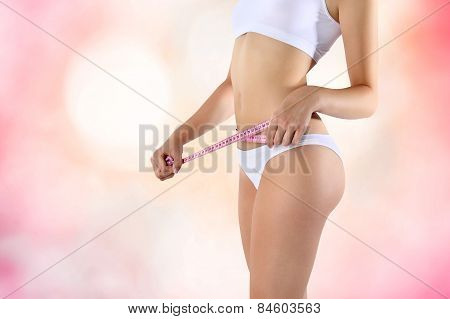 meter diet on the belly pink background