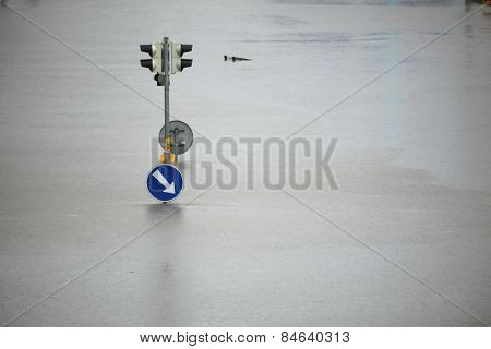 PRAGUE, CZECH REPUBLIC - JUNE 3, 2013: Flooded crossroad with traffic lights and a keep right traffic sign partially flooded by the swollen Vltava River in Prague, Czech Republic.