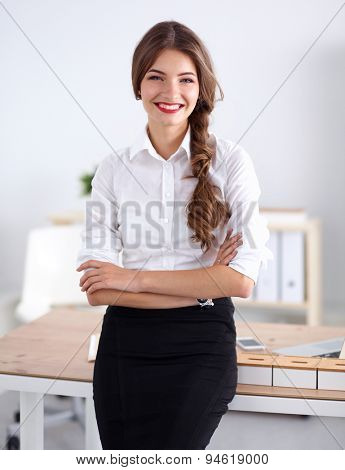 Attractive businesswoman with her arms crossed stnding